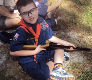 Caden shooting a Daisy BB Gun at Cub Scout Camp